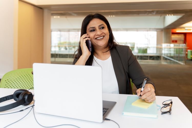 Smiling woman answering phone